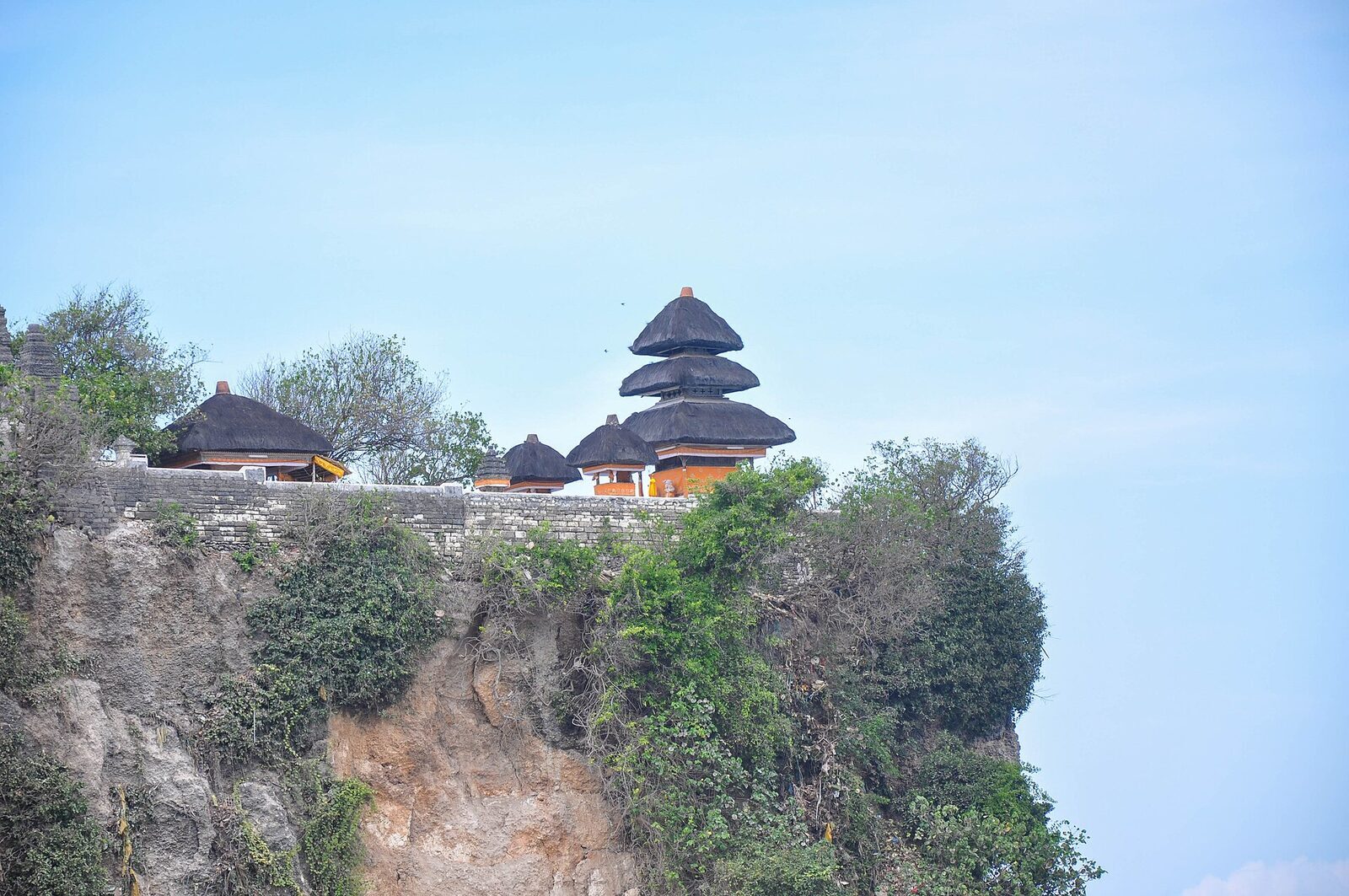 A pura segara — the sea temple facing the open Indian Ocean, its thatched meru on the cliff.