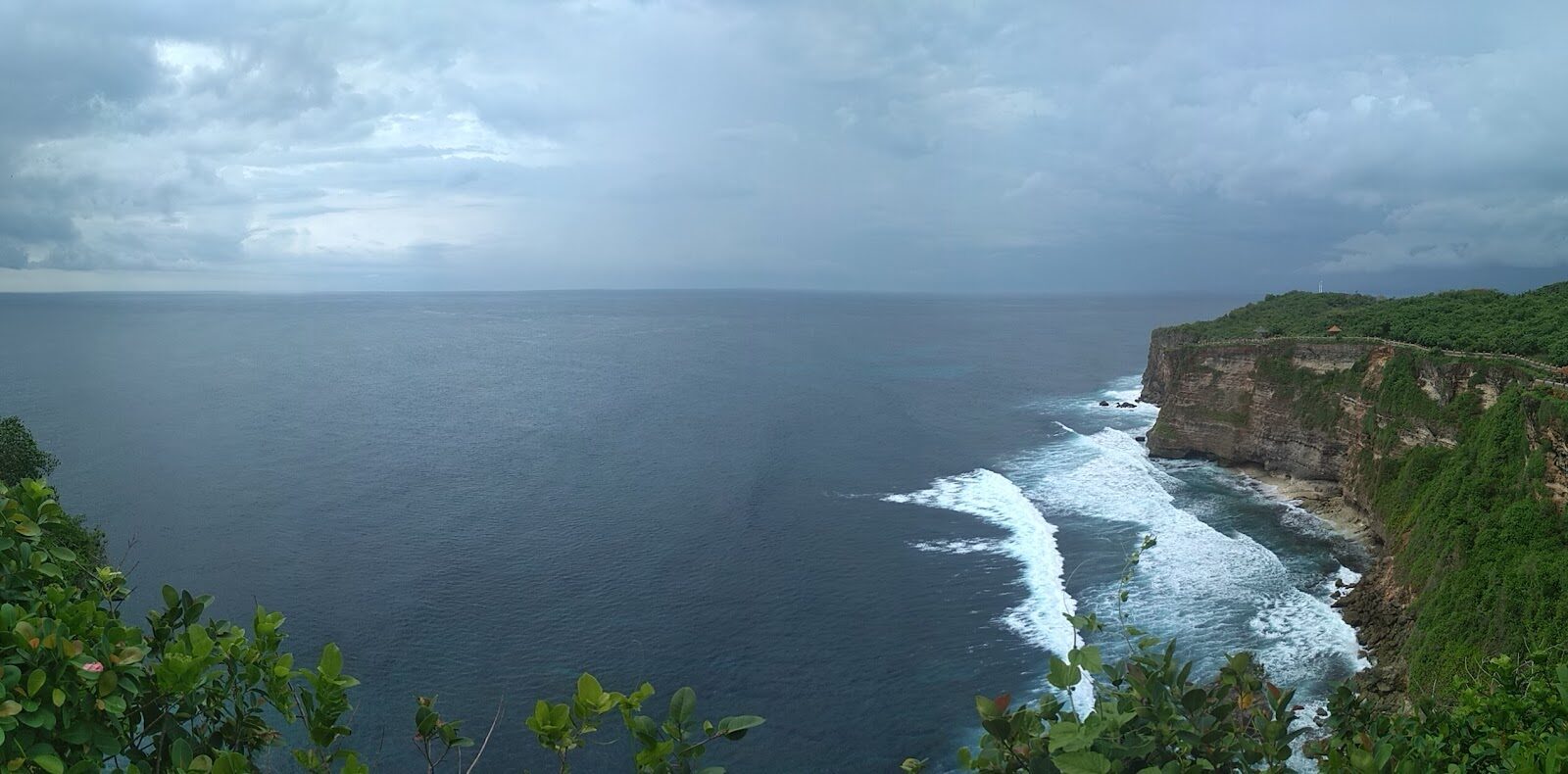 The raw limestone the whole complex stands on, cut sheer by the ocean.