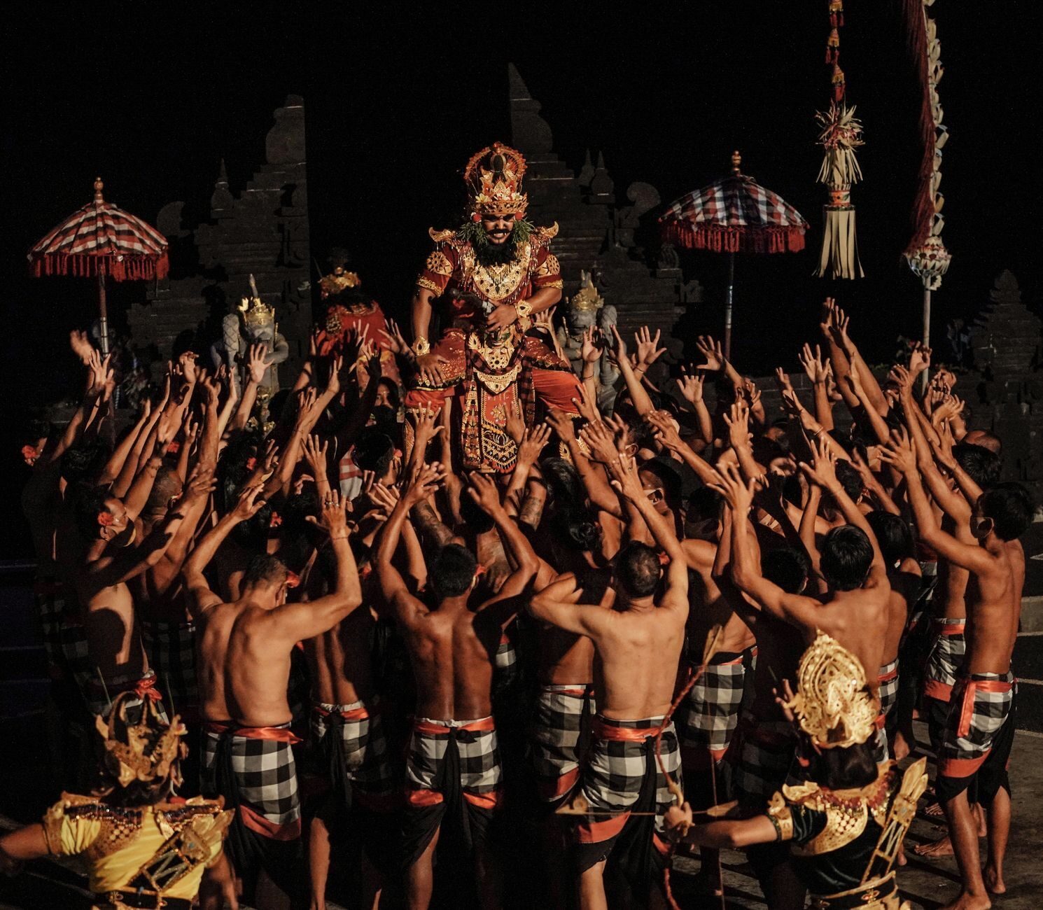 The chorus with arms up around the principals — the men are the entire orchestra.