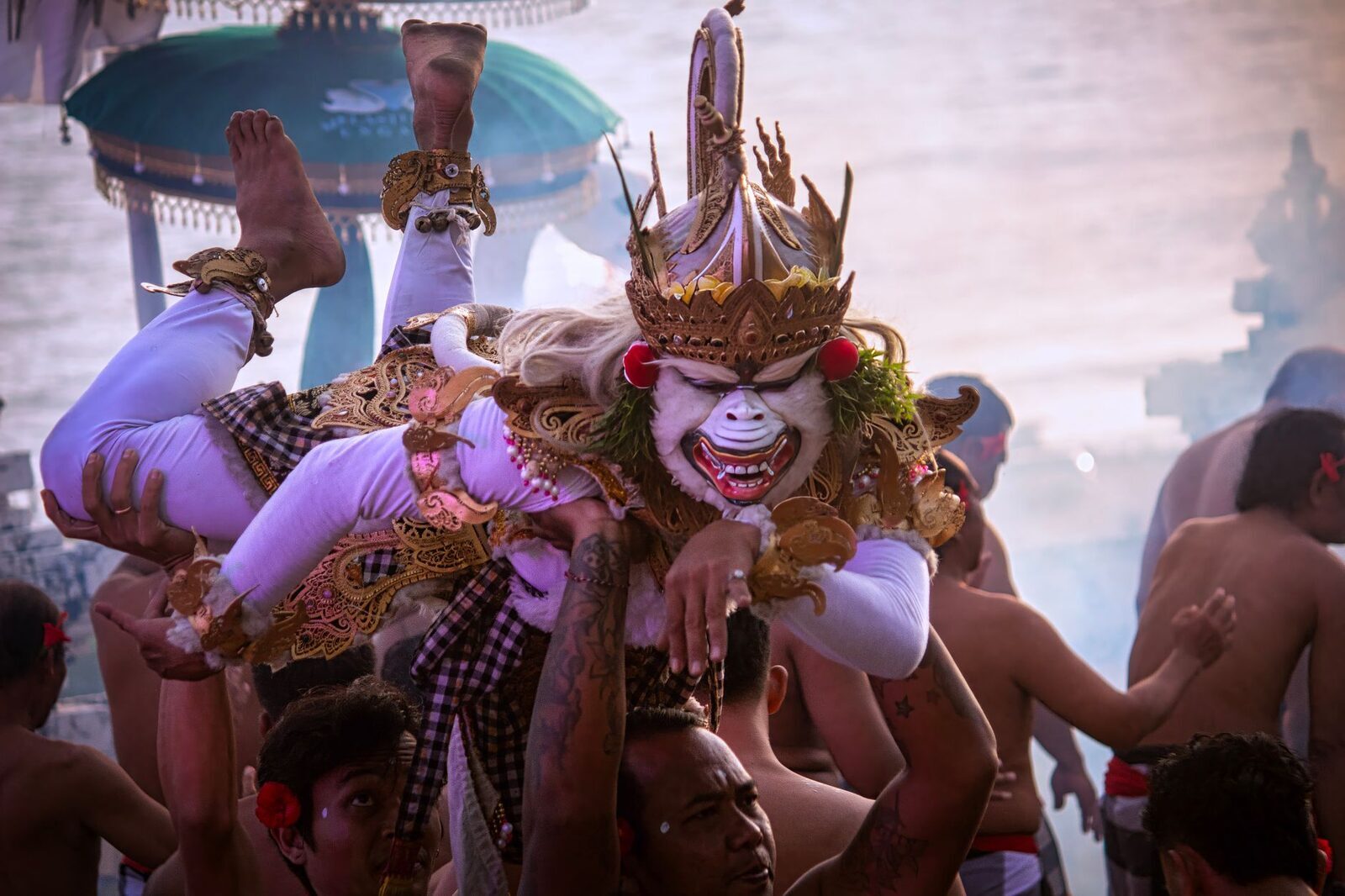 Hanuman, the monkey general, in a gilded mask — a Ramayana role, not the 'monkey imitation' the chant gets sold as.