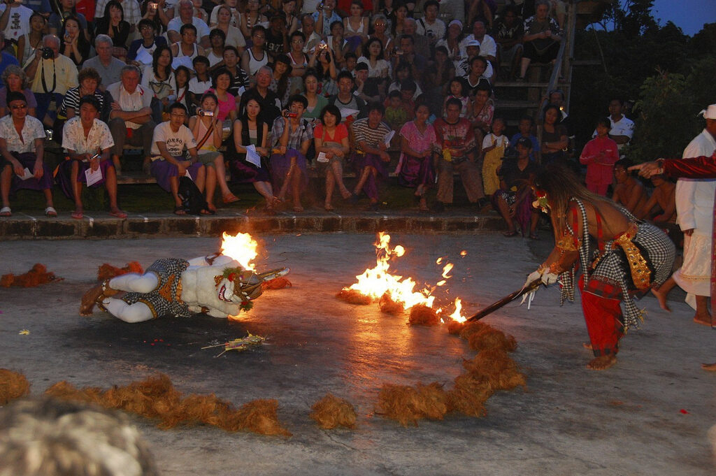The fire-horse dance close to the coals, the crowd banked around.