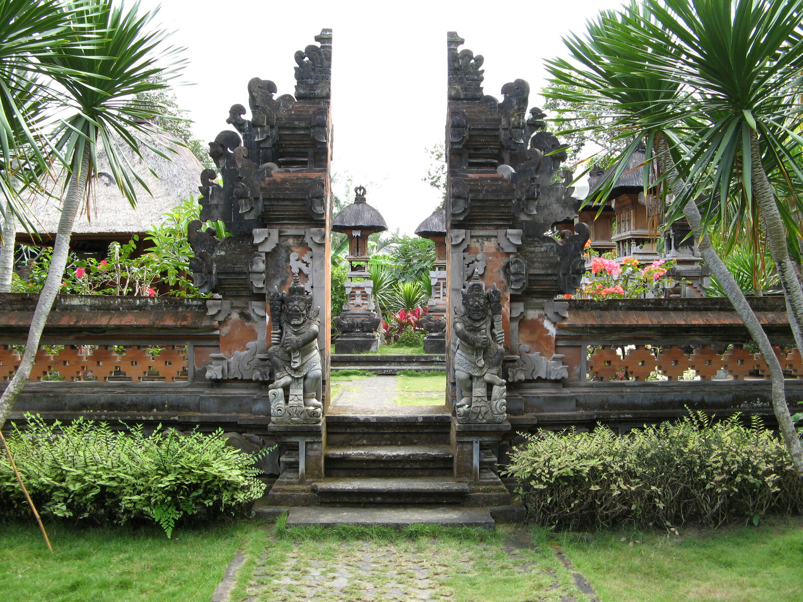 A split gate above flowered steps, the two halves mirror-matched.