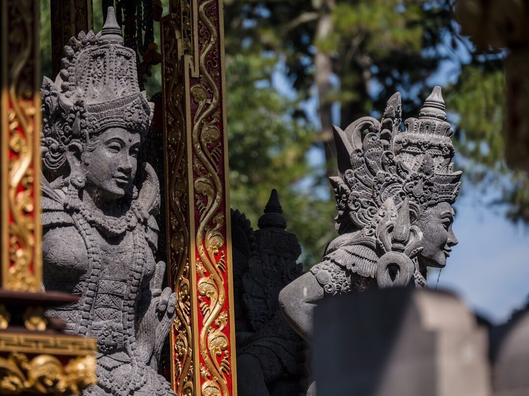 A pair of ornate stone guardian statues flanking a temple gate.