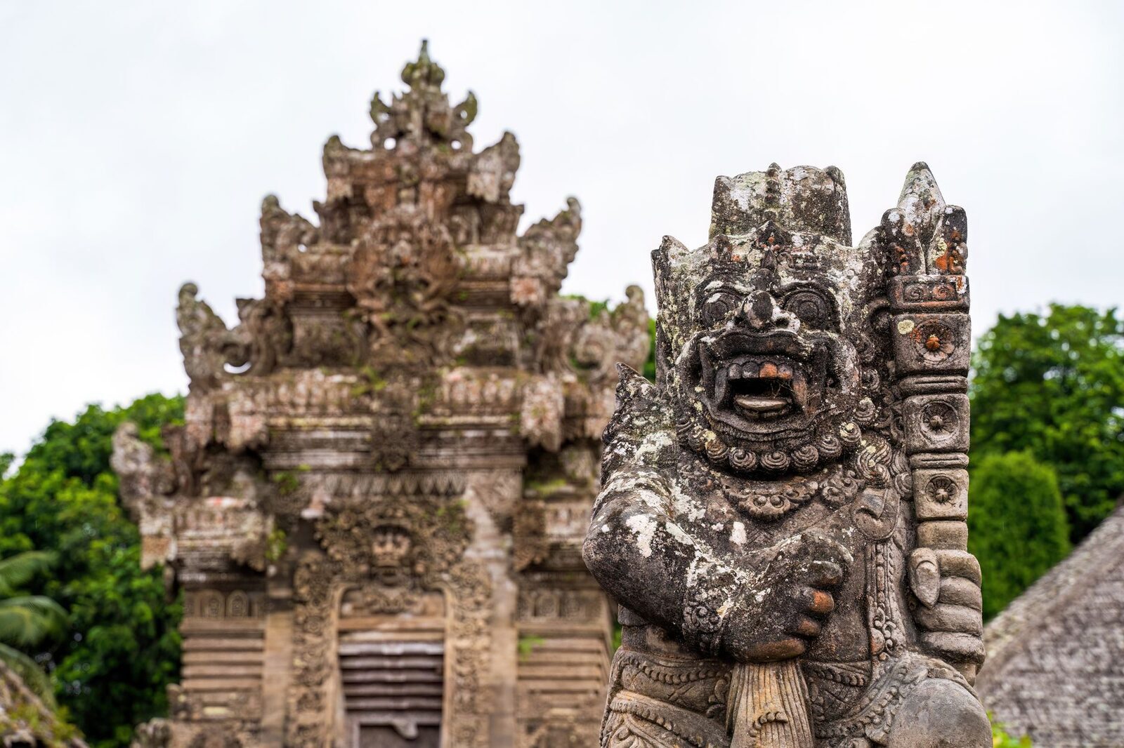 Grotesque guardian figures crowning a Balinese gate.