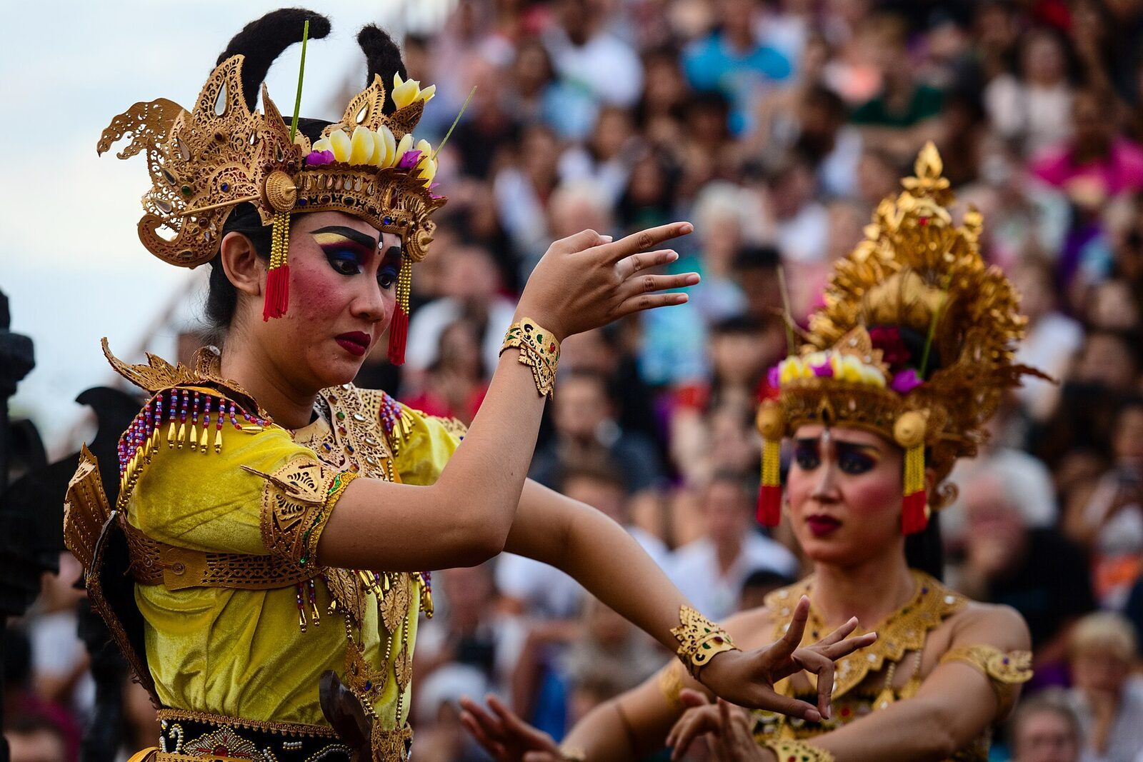 A costumed Kecak dancer in an ornate gilded headdress.