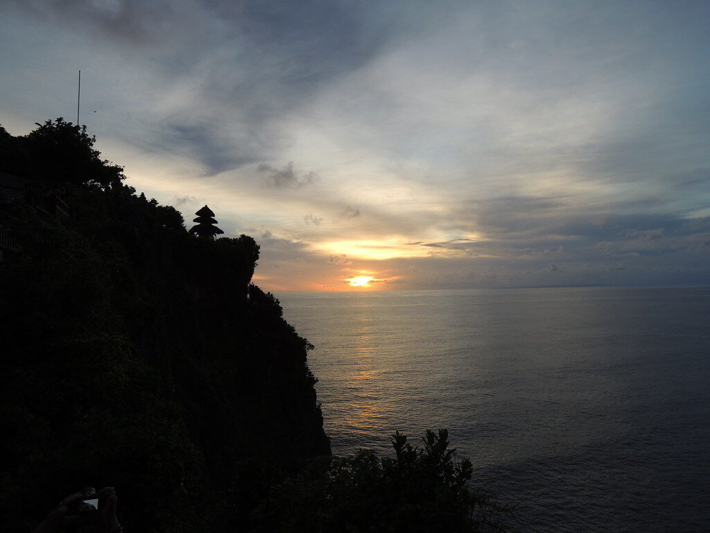 The sun dropping into the ocean from the Uluwatu cliffs.