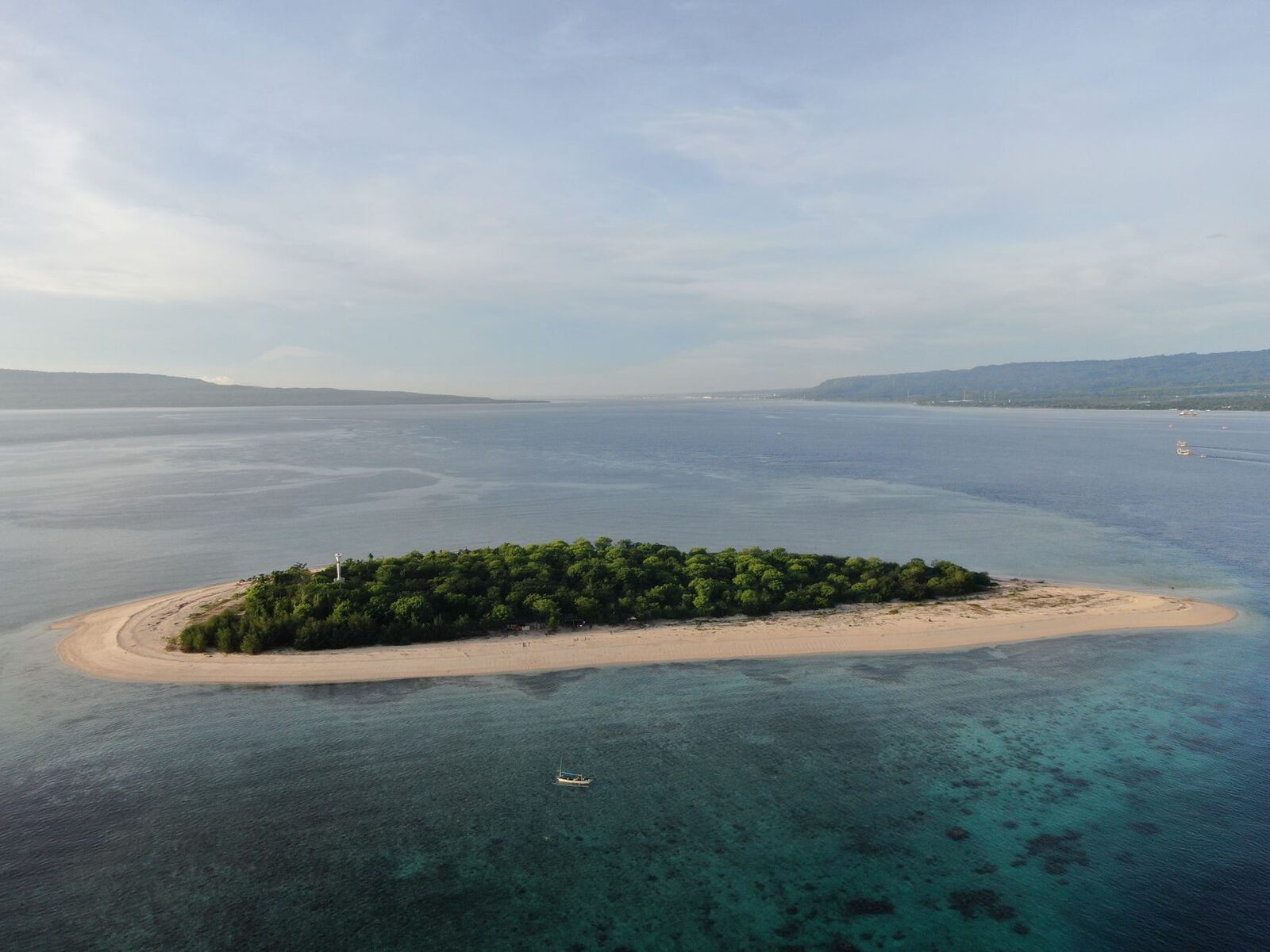 A sand-spit islet ringed by reef in the national park's waters — the wild, empty edge of Bali most people never reach.
