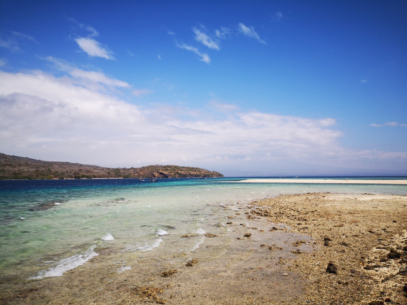 A shallow reef flat running straight off the beach — you can snorkel it from the sand.