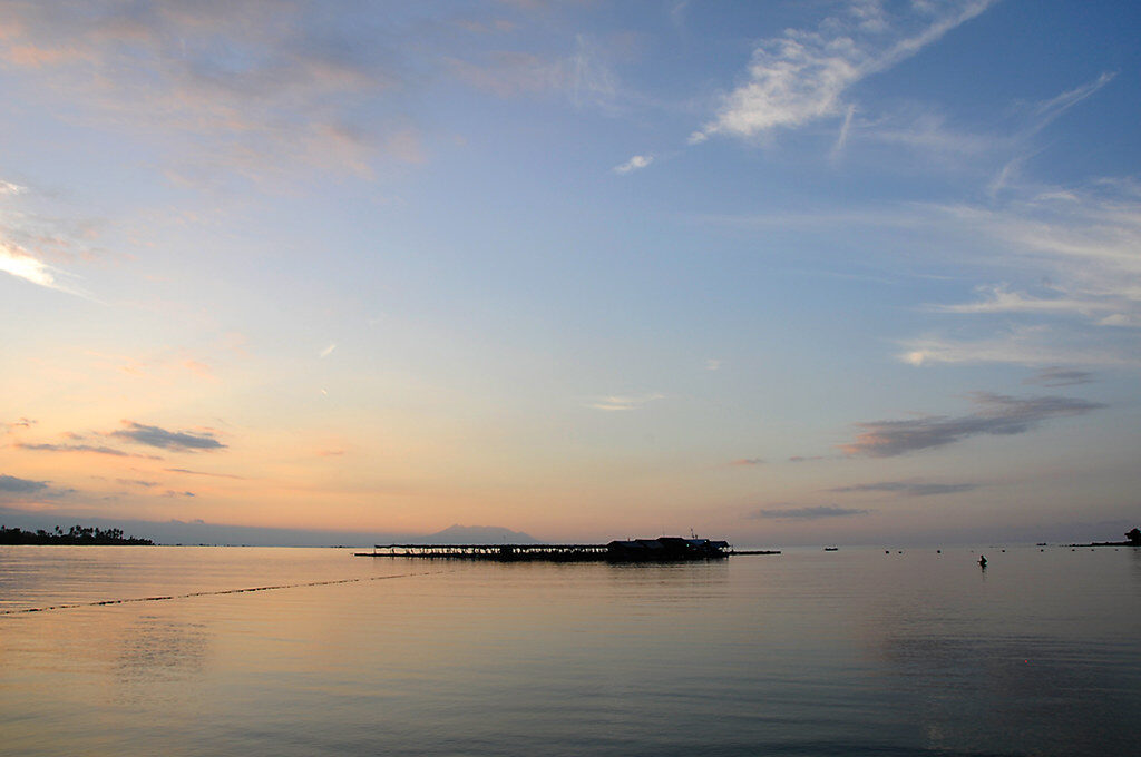 A quiet north-coast bay at first light — the kind of calm, low-key water Pemuteran sits on.