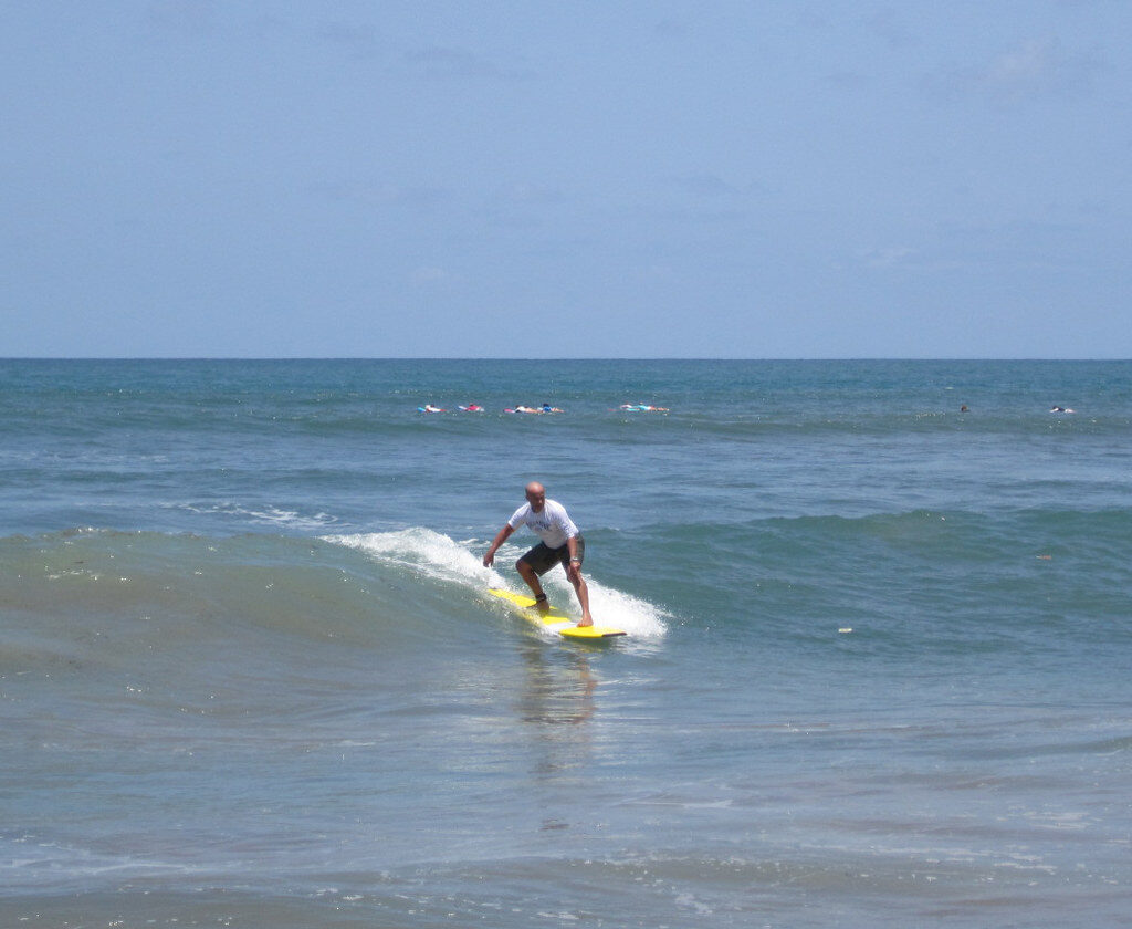 A surfer on one of Canggu's beginner-friendly beach breaks.