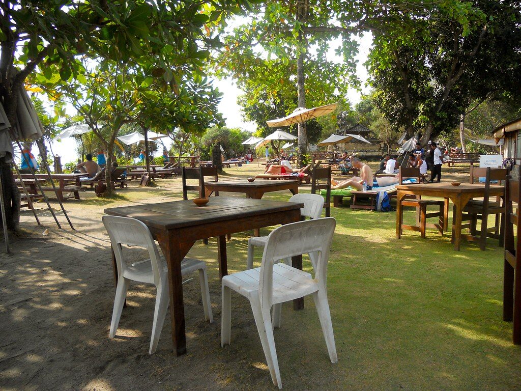 Garden dining tables under the palms — Seminyak has the island's strongest restaurant-and-bar scene.