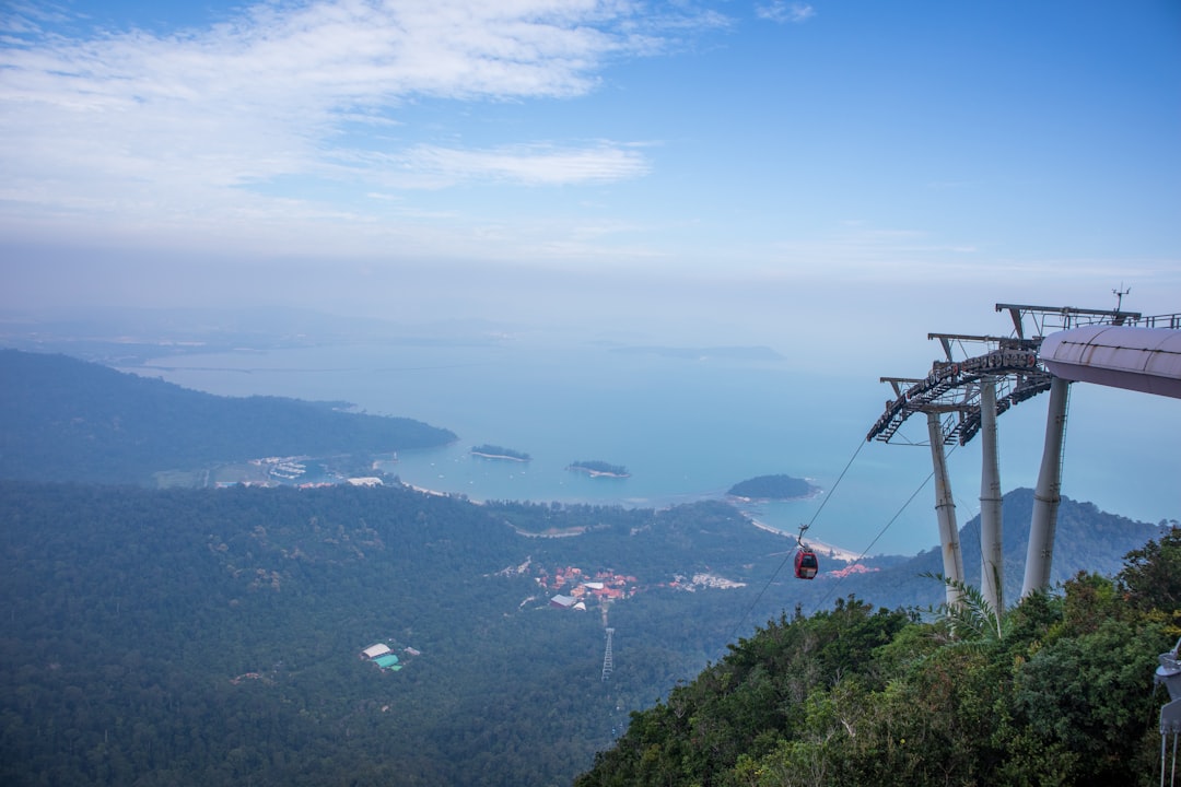 A Langkawi SkyCab gondola climbing the forested slope of Machinchang.